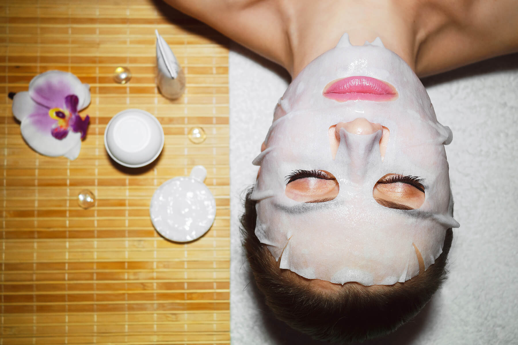 Woman laying down while wearing a natural face mask
