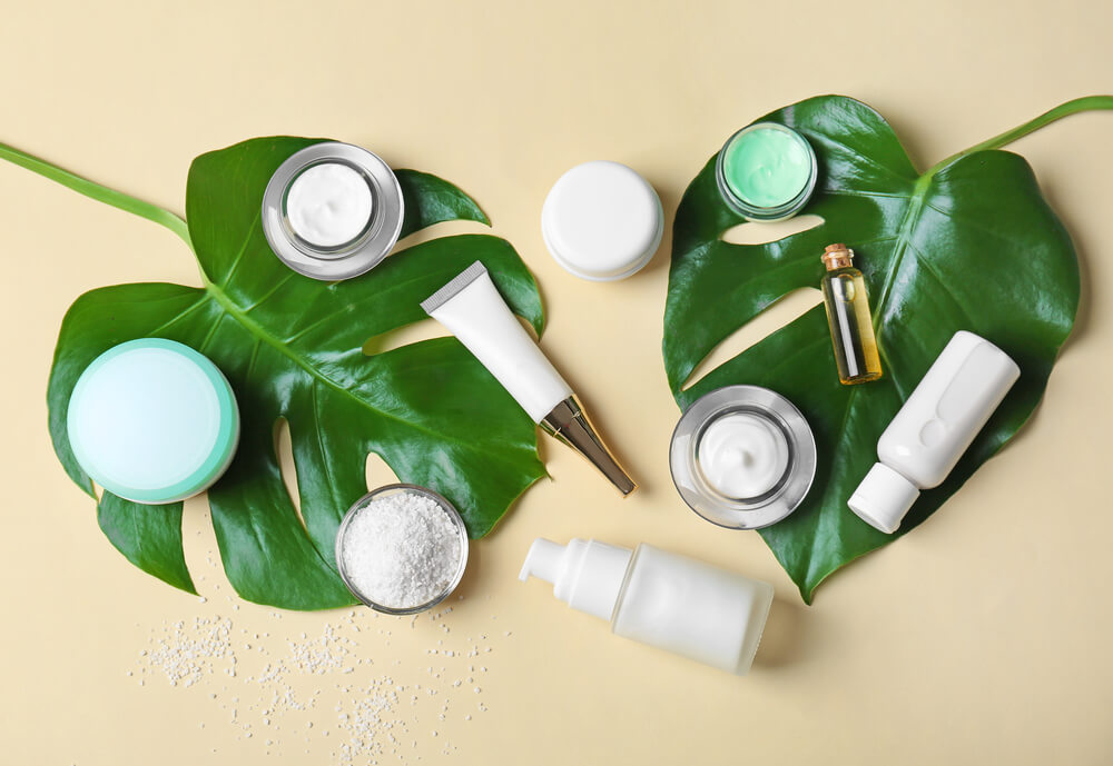 skin care products arranged on leaves