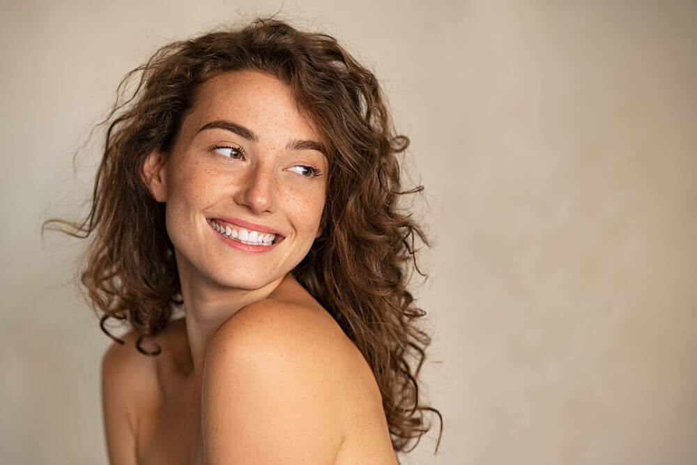 girl smiling with bright, healthy-looking skin