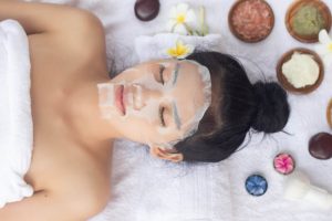 Woman using custom sheet mask with nutrients