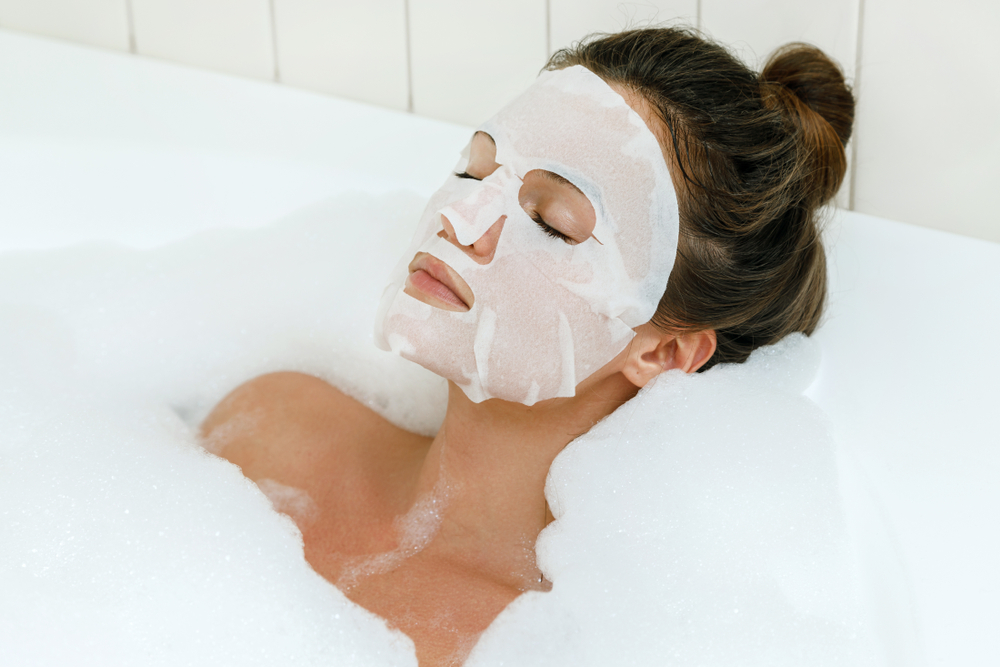 Woman in bathtub using sheet mask Seoul Mamas