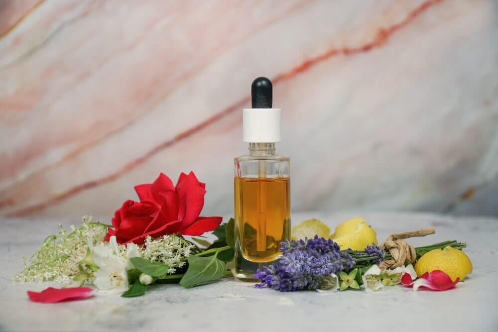 A K-beauty face serum surrounded by flowers